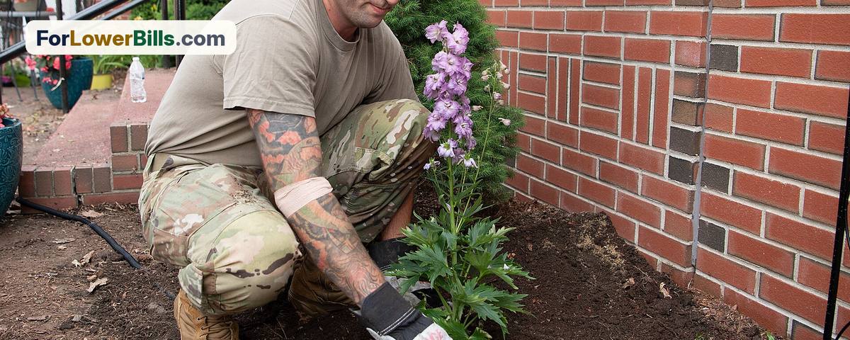 Volunteer planting flowers in a community garden