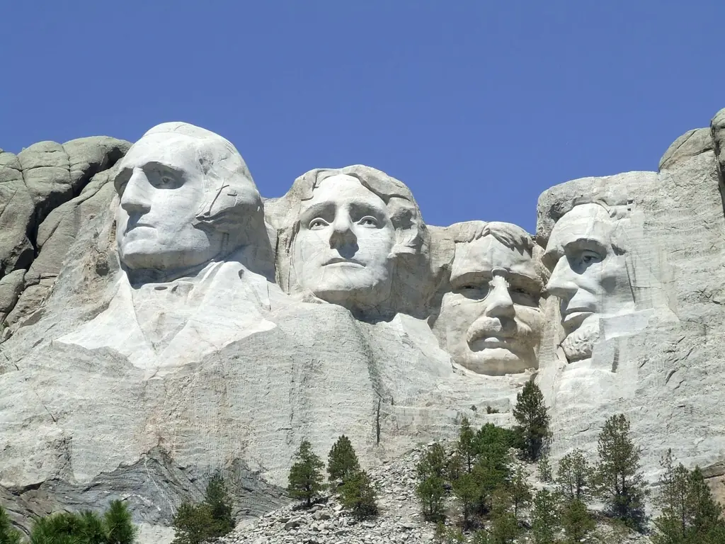 Mount Rushmore National Memorial with the carved faces of four presidents against a blue sky