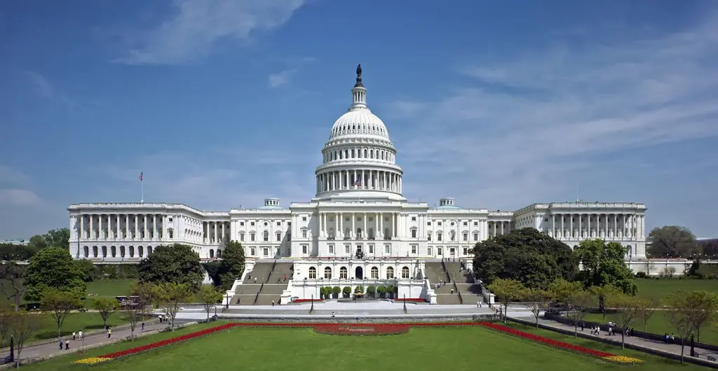 West front of the U.S. Capitol with its white dome above a green lawn